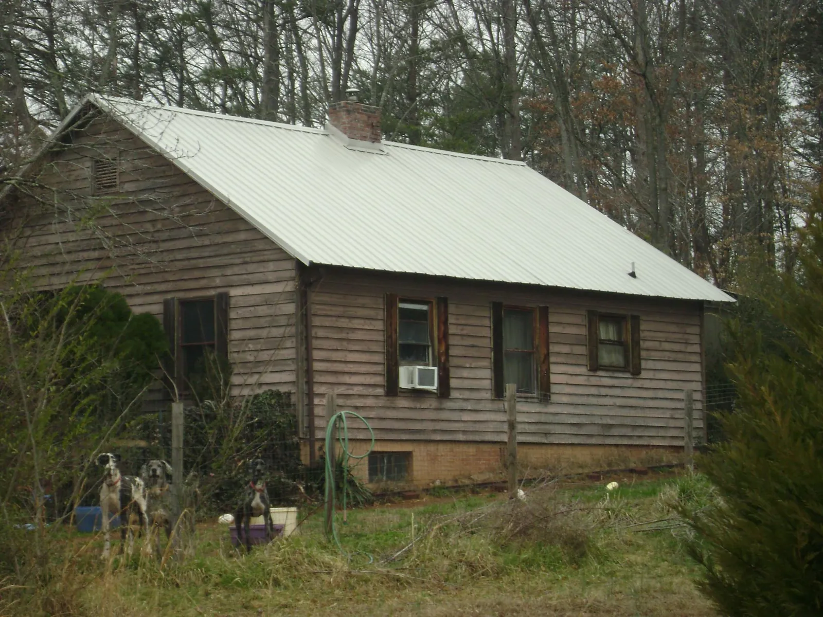 White metal roof on an old wood sided farmhouse, from a Metal Roof Installation job in Zieglerville